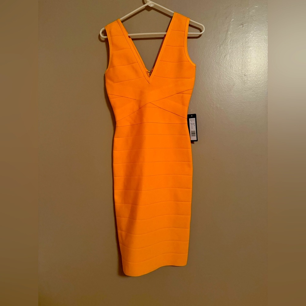 Bebe Double V Mini Bandage dress
Amber Yellow
Size XS